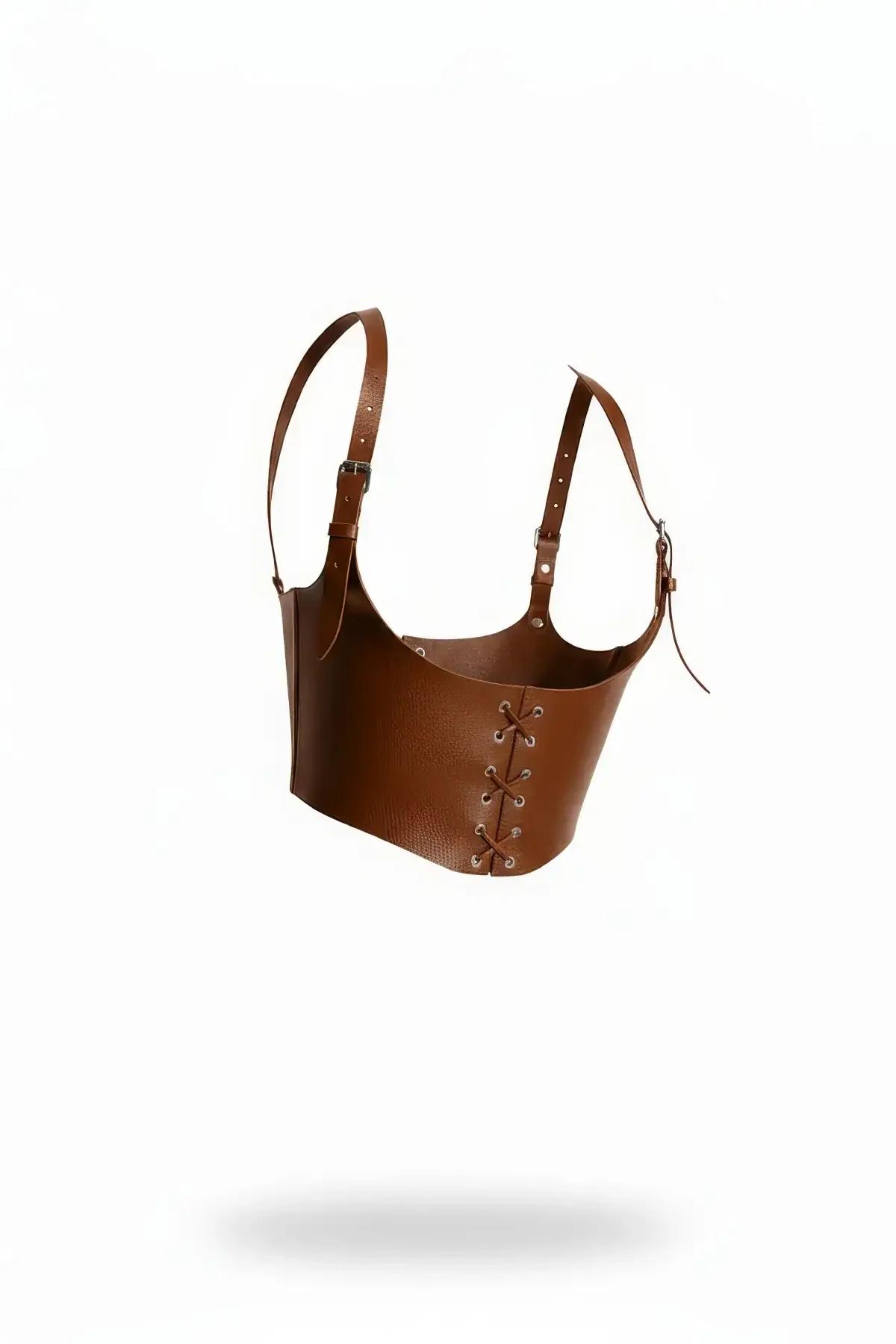 Cognac faux leather underbust harness with lace-up front eyelets and wide adjustable shoulder straps, side-angle view