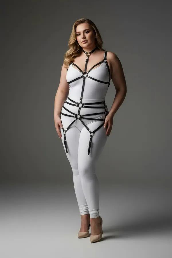 Black faux leather full body harness with choker neck, V-chest straps, four waist bands, and silver garter clips worn over wh