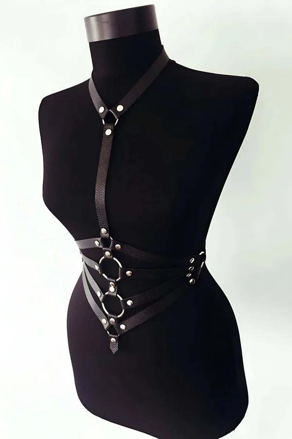 Black faux leather body harness with five stacked octagonal O-rings, silver rivets, collar strap and waist bands on mannequin