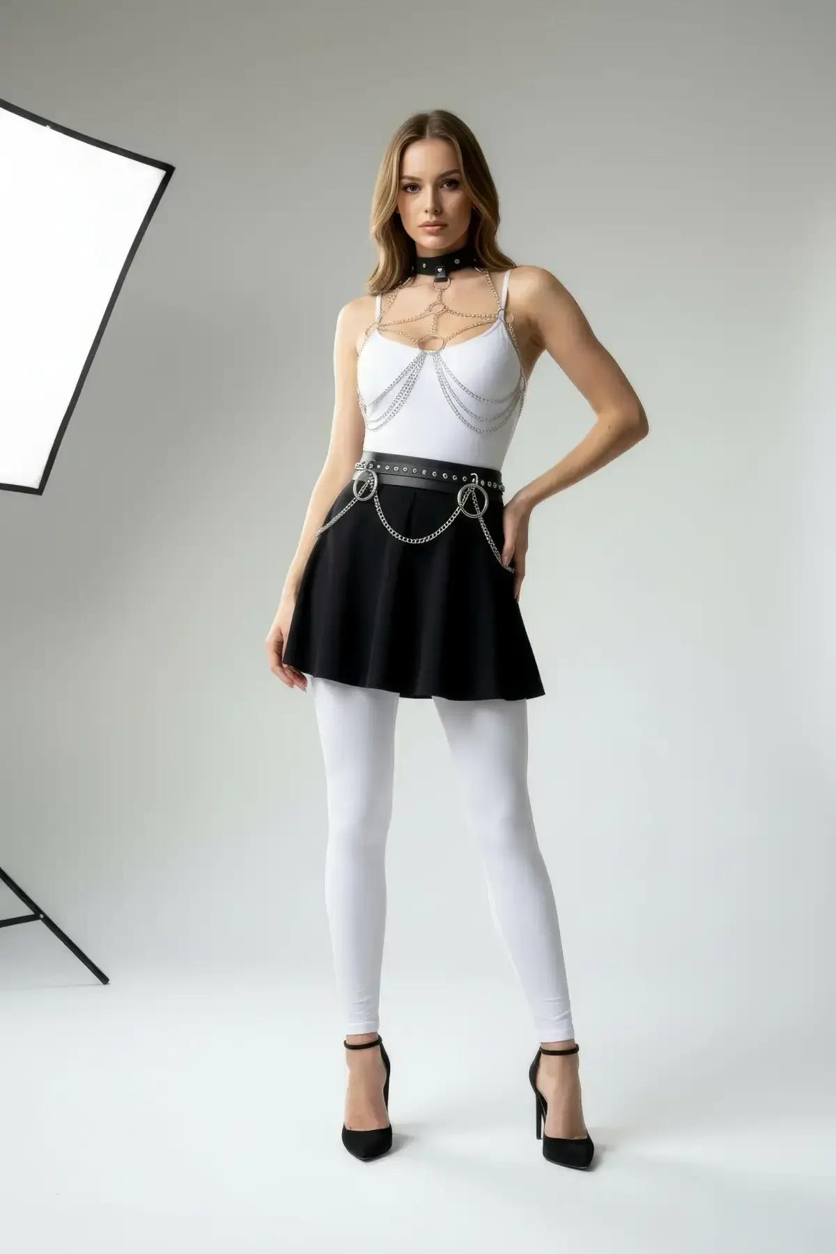black faux leather choker body chain and O-ring waist belt set with silver stud and chain detail worn over white bodysuit