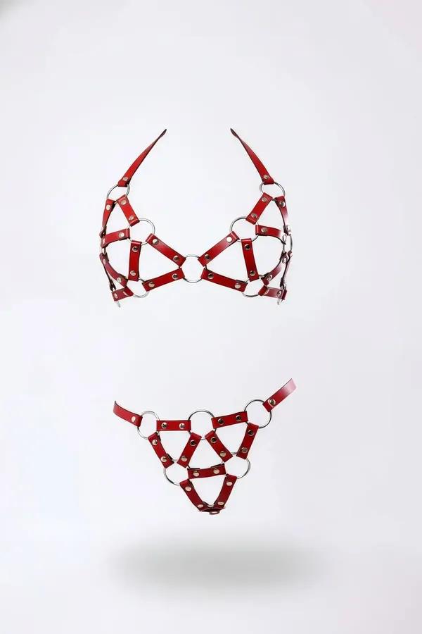 red faux leather caged harness bra and g-string set with silver O-rings and eyelet rivets on white background