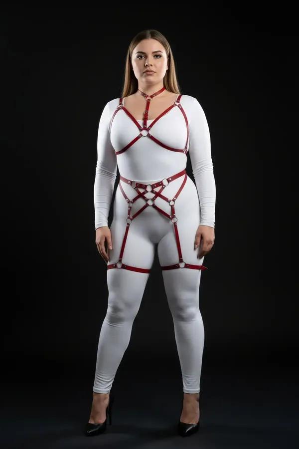 red faux leather strappy body harness set with silver O-rings chest harness waist panel and thigh garters on plus size model
