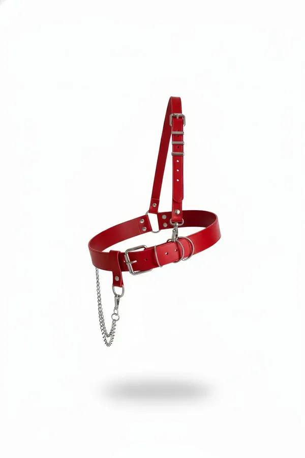 Red faux leather waist harness with single adjustable shoulder strap, silver O-ring buckle, and hanging silver chain on white