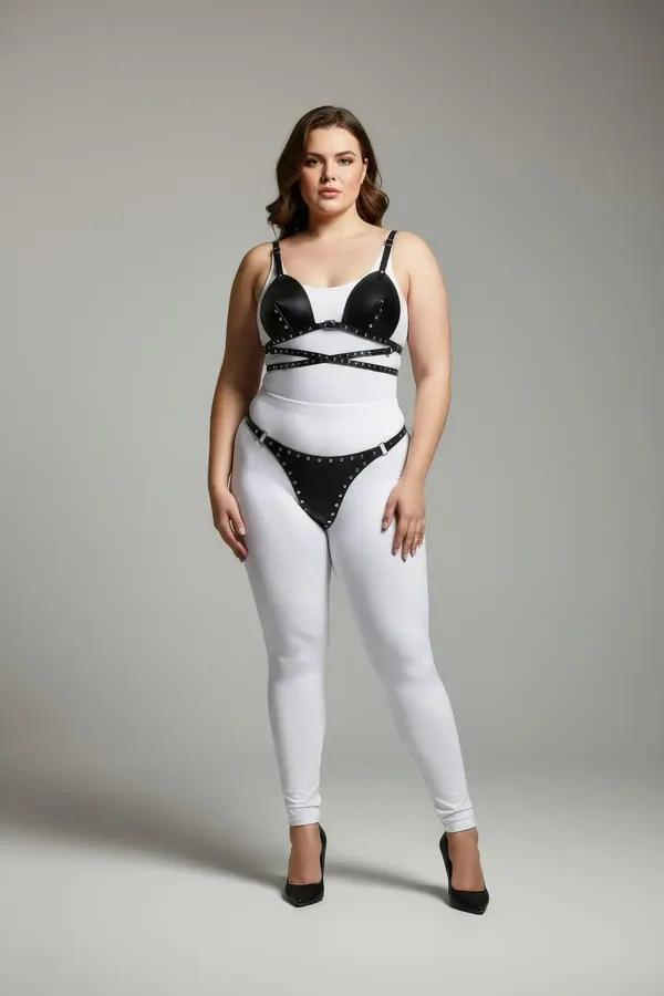black faux leather studded bra top and thong harness set with silver eyelet trim on all straps and cup edges