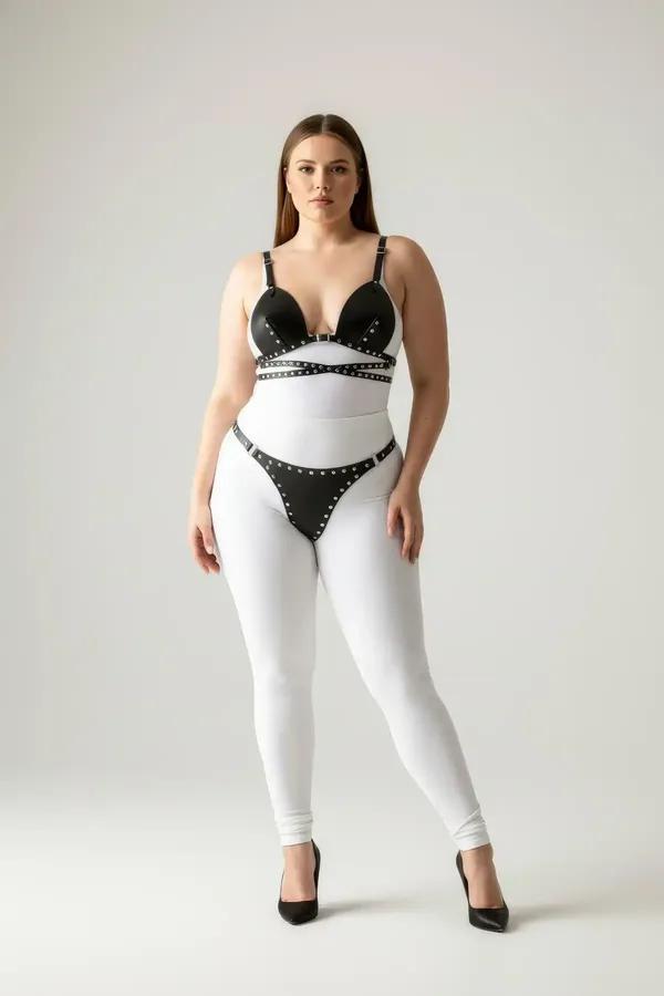 black faux leather studded bra top and thong harness set with silver eyelet trim on all straps and cup edges