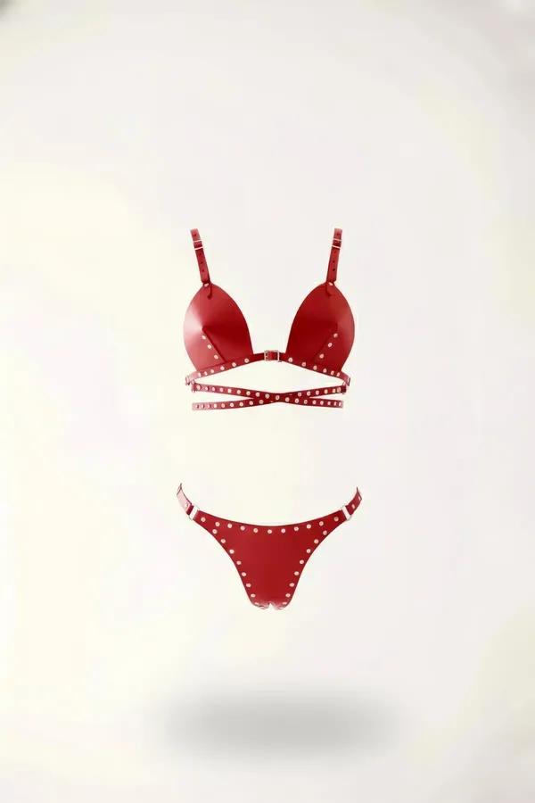 Red faux leather harness bralette and thong set with silver dome studs along edges and crossover underbust strap band