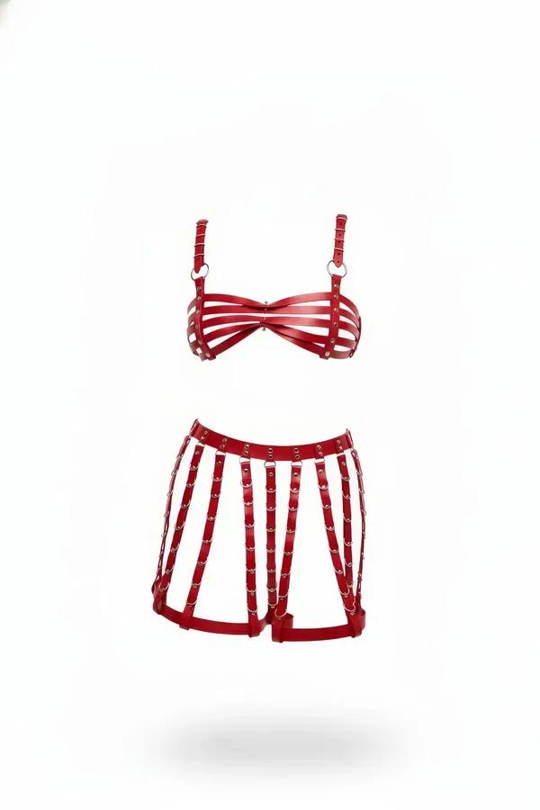 Red caged faux leather bra and harness shorts lingerie set with silver O-rings and rivets on white background