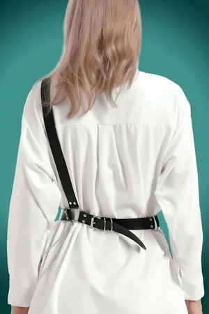 Black Faux Leather Chest Harness Belt with Triple Buckle and Chain Accents worn over white shirt