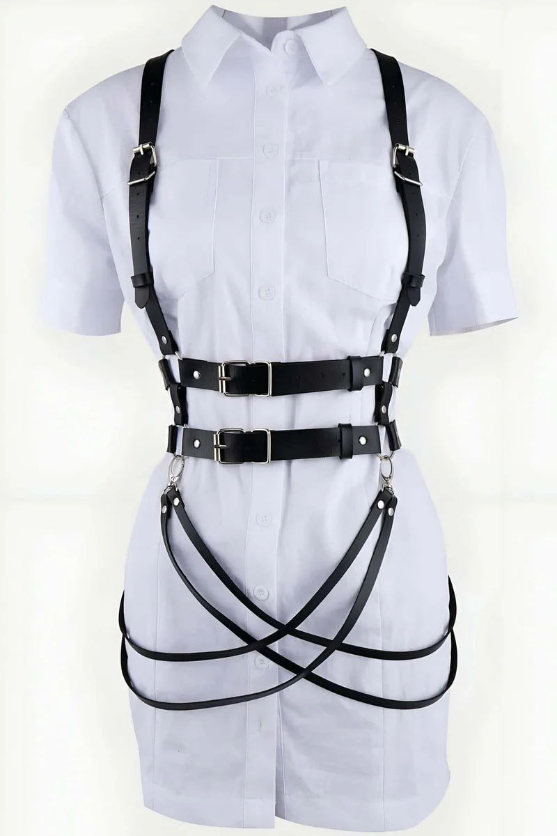 Black adjustable body harness with multiple straps and buckles on white shirt