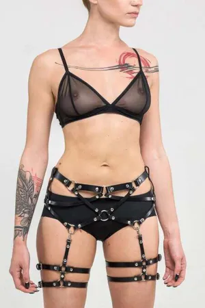 Black Faux Leather Leg Garter Harness with O-Rings and Buckles, worn on a model