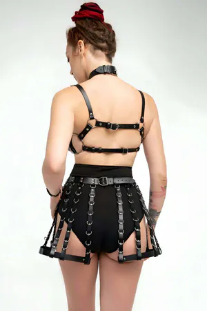 Black Faux Leather Cage Bra and Skirt Harness Set on model with O-rings