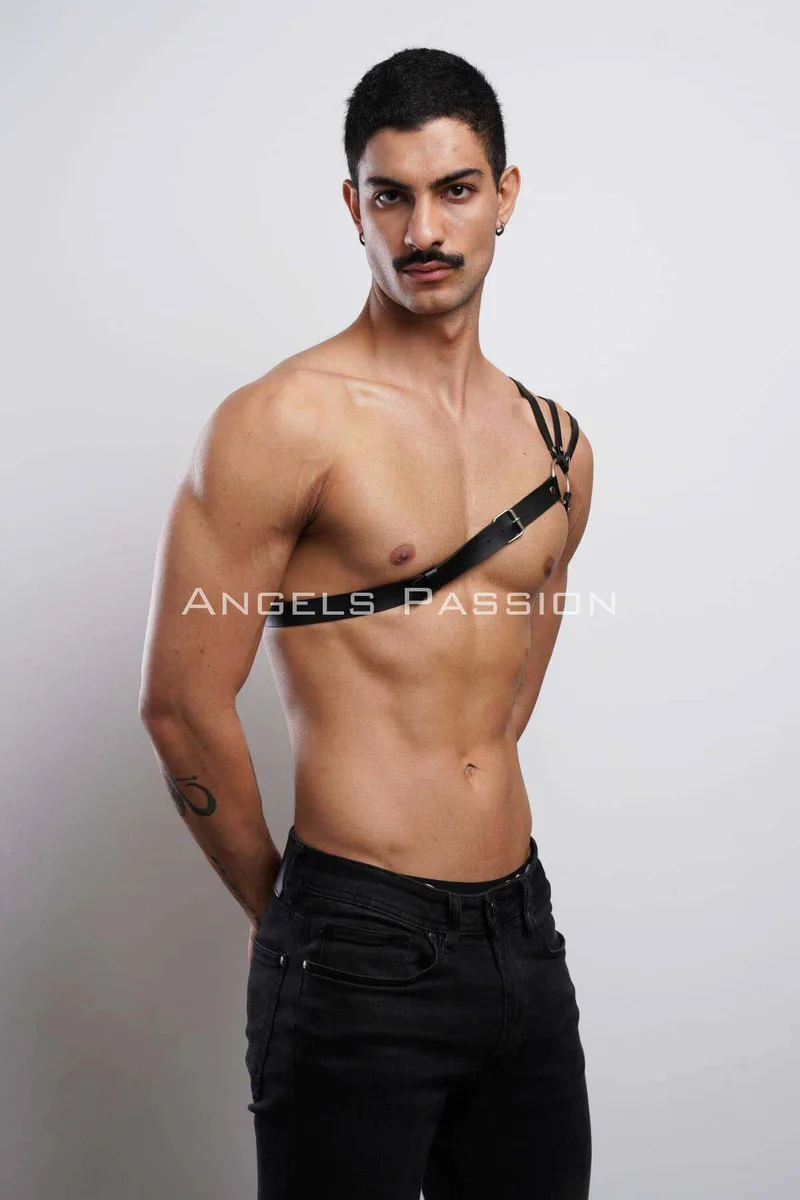 Black vegan leather shoulder harness worn over right