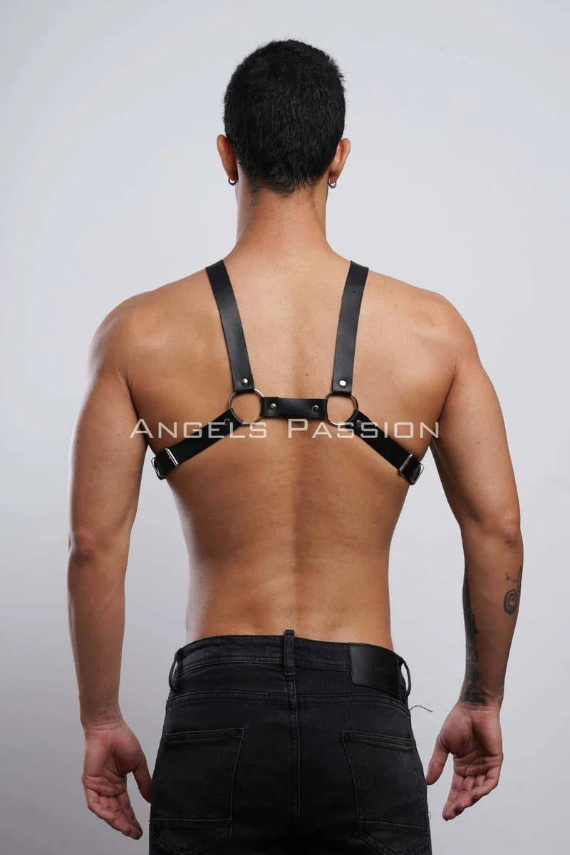 Black faux leather body harness with adjustable straps back view showing central metal hardware and crossback design
