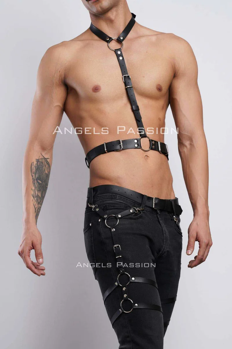 Detail of black faux leather leg garter with O-rings and adjustable straps.