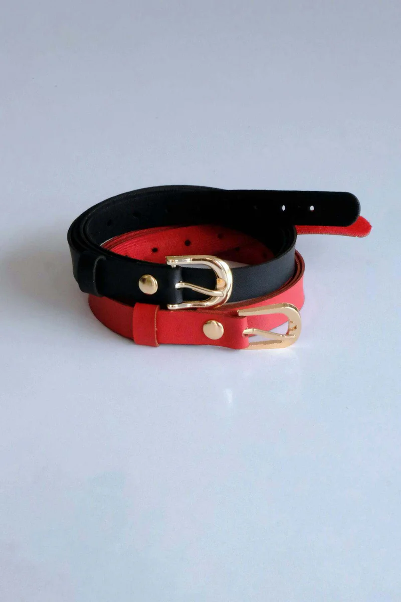Close-up of buckle on red slim faux leather belt with hardware.