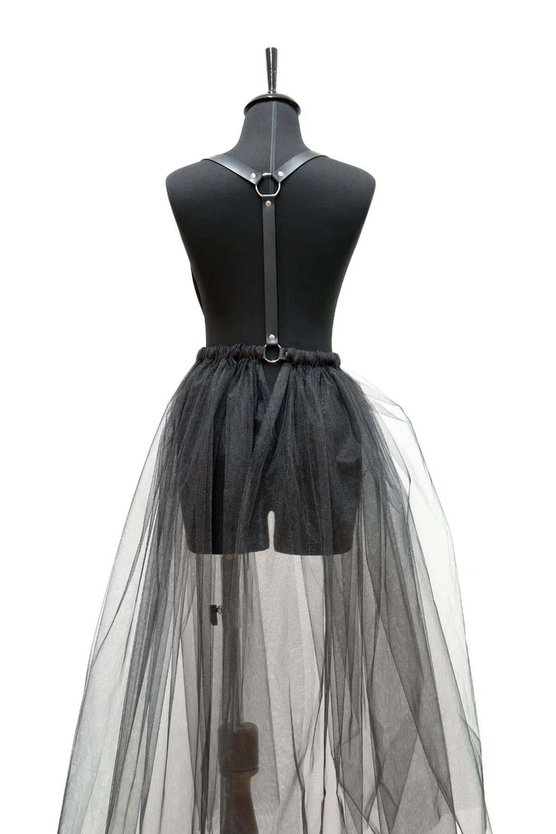 Close-up of black faux leather harness detail on tulle skirt adjustable straps