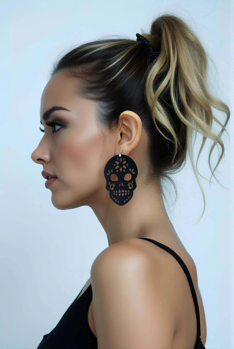 Black Laser Cut Sugar Skull Earrings with ornate floral details worn by a model
