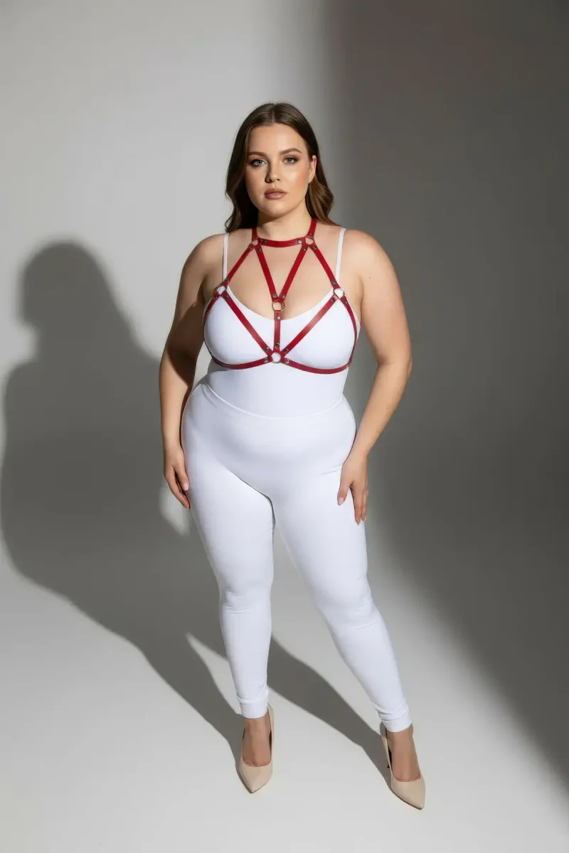 Red strappy harness on model with white bodysuit side profile
