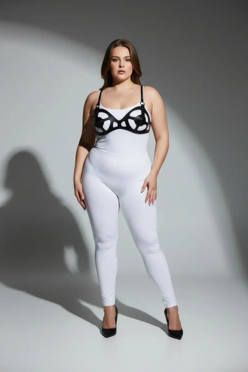 Plus size model wearing black faux leather cage bra harness side profile