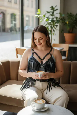 Black Fringe Faux Leather Chest Harness and Waist Belt Set worn over a cream top and mint trousers